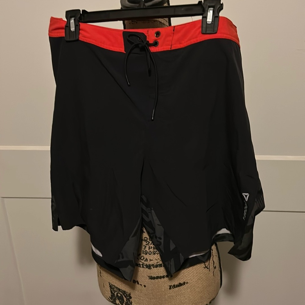 These r Reebok shorts in blk & red.